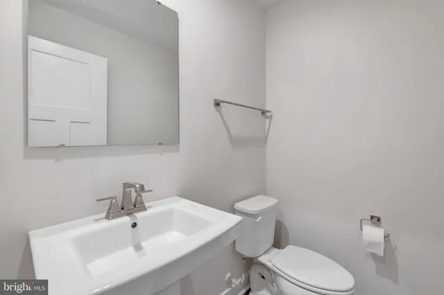 a white toilet sitting next to a bathroom sink