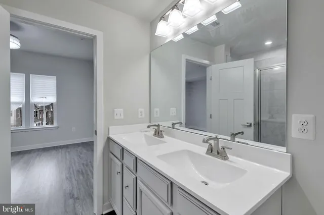 a bathroom with a sink double vanity and a mirror