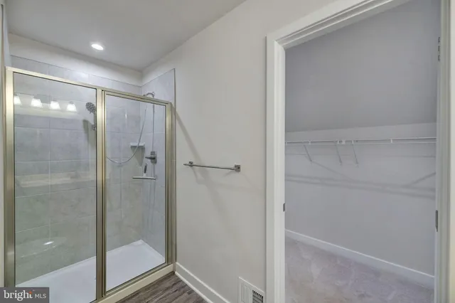 a bathroom with a glass shower door