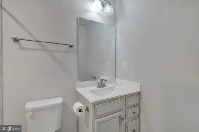 a bathroom with a sink toilet and vanity