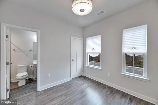 a view of a room with wooden floor and window