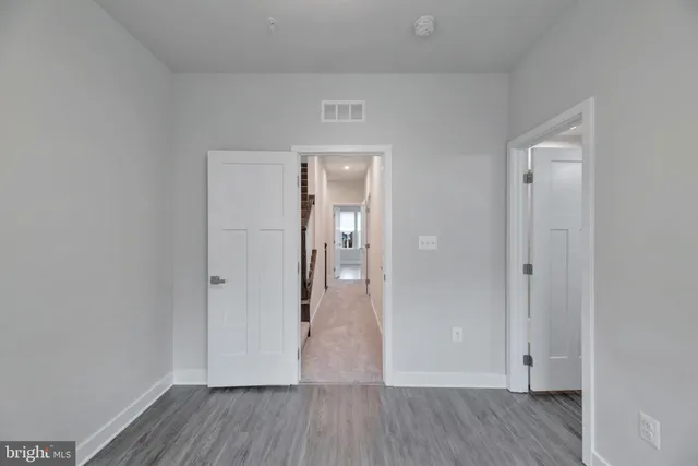wooden floor & wooden door in an empty room