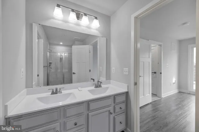 a bathroom with a sink double vanity and a mirror