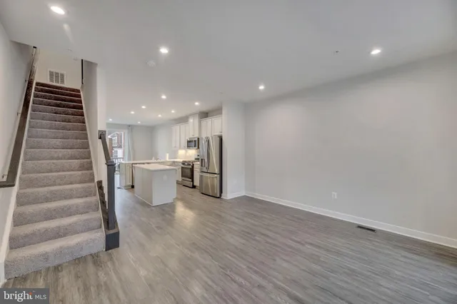 a view of kitchen and hall with wooden floor