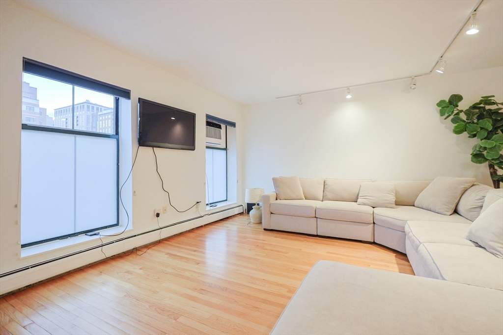 69 East Berkeley Street, Unit 1 Boston, MA 02118 - Photo 5 of 20 a living room with furniture and a flat screen tv