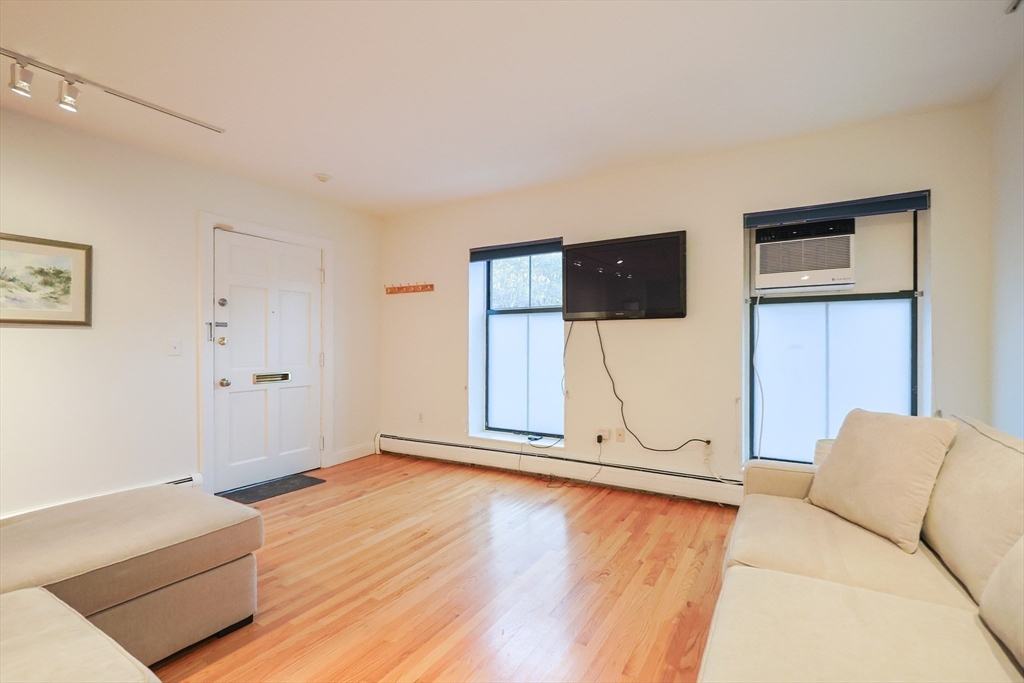 69 East Berkeley Street, Unit 1 Boston, MA 02118 - Photo 7 of 20 a living room with furniture and a flat screen tv