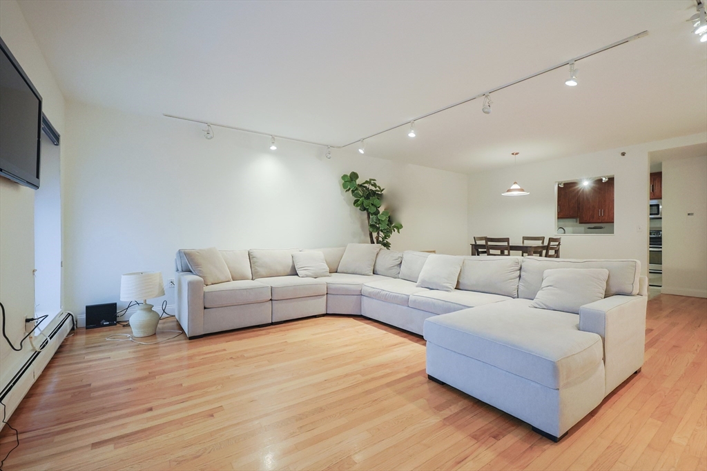 69 East Berkeley Street, Unit 1 Boston, MA 02118 - Photo 8 of 20 a living room with furniture and a wooden floor