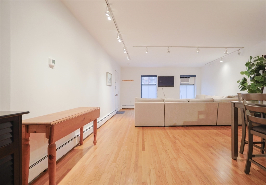 69 East Berkeley Street, Unit 1 Boston, MA 02118 - Photo 9 of 20 a living room with stainless steel appliances wooden floors and view living room