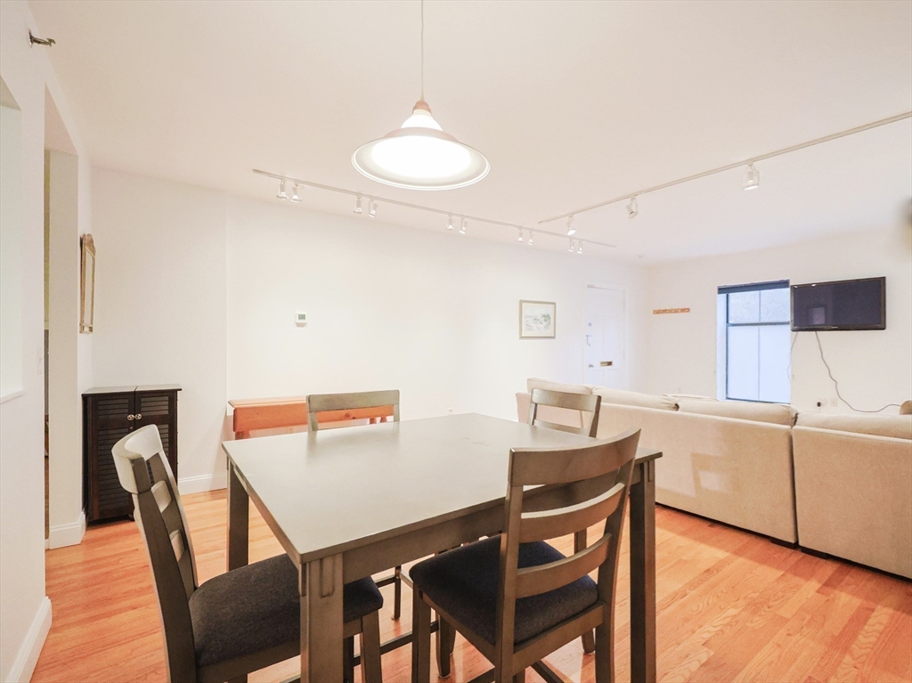 69 East Berkeley Street, Unit 1 Boston, MA 02118 - Photo 10 of 20 a view of a dining room with furniture and wooden floor
