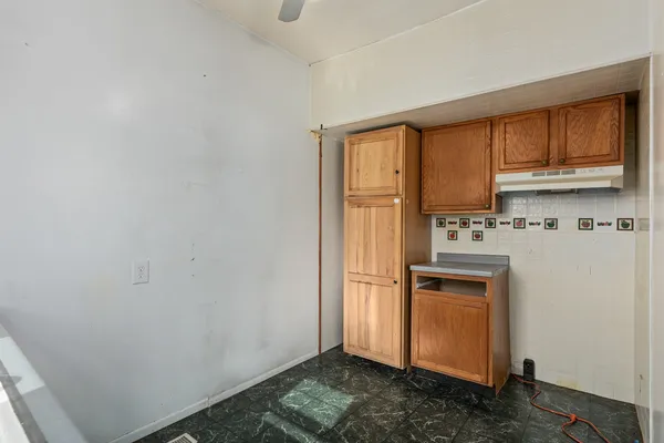 a kitchen with stainless steel appliances a refrigerator and a stove top oven