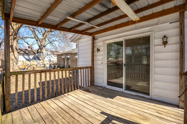 a view of a balcony with wooden floor