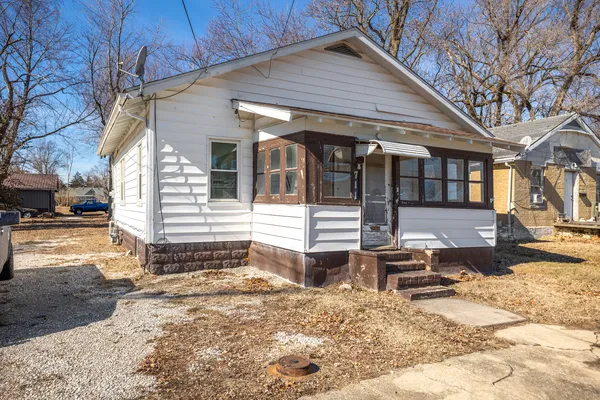a view of a house with snow on the road