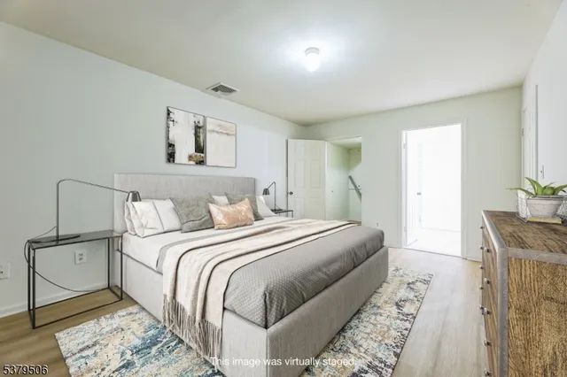 a bedroom with a large bed and a chandelier