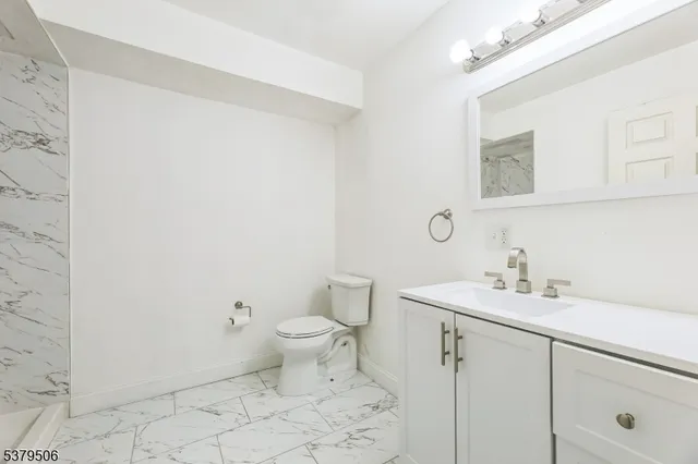 a bathroom with a sink a toilet and mirror