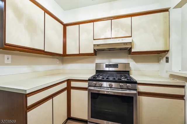 a kitchen with stainless steel appliances granite countertop a stove and a microwave