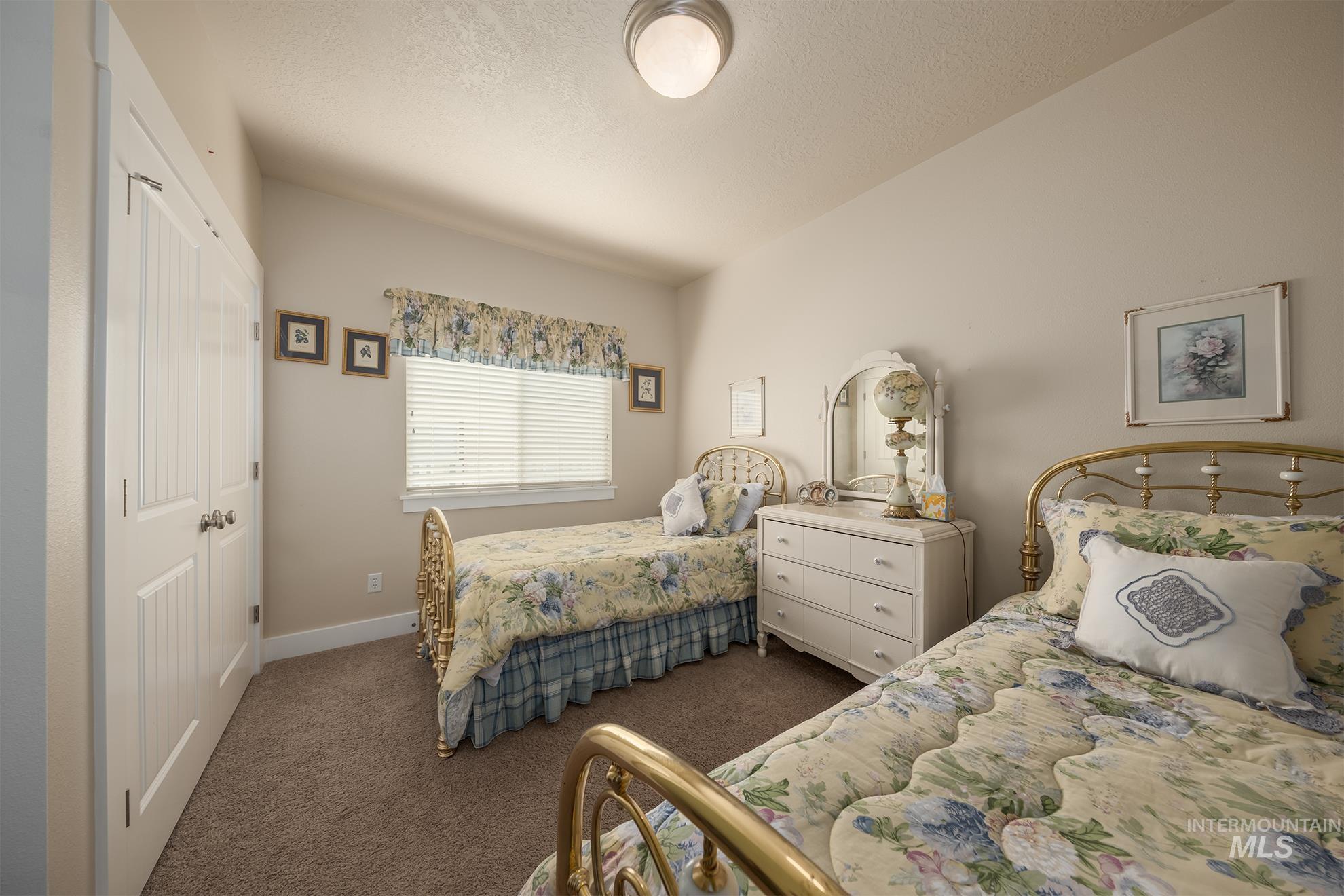 420 West Indianhead Road Weiser, ID 83672 - Photo 21 of 40 Carpeted room featuring a ceiling light fixture, white bi-fold closet doors, a single window with blinds, and light-toned walls