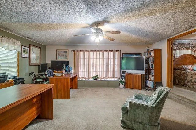 a bedroom with furniture and a window