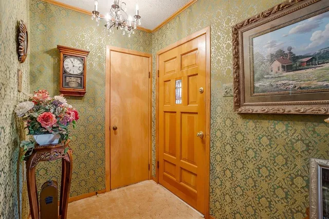 a living room with furniture a flat screen tv and a large window