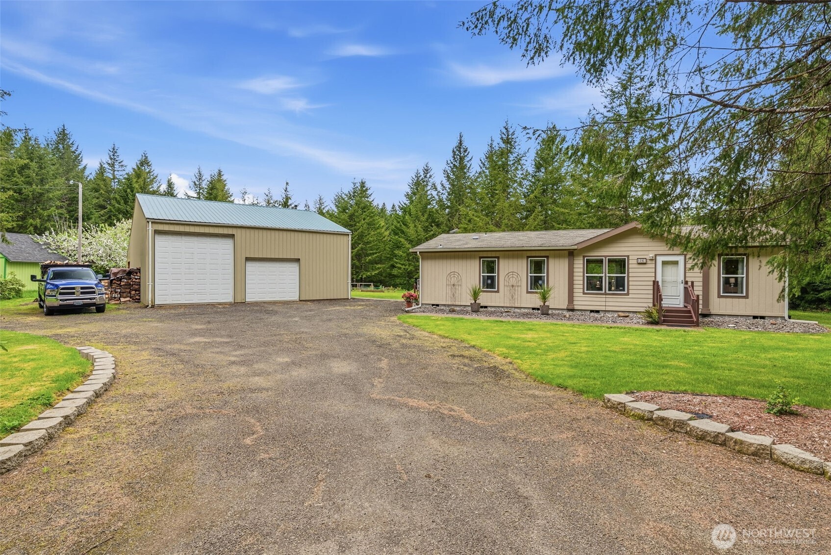 1047 Beaver Creek Road Cathlamet, WA 98612 - Photo 1 of 39 a front view of a house with a garden and trees