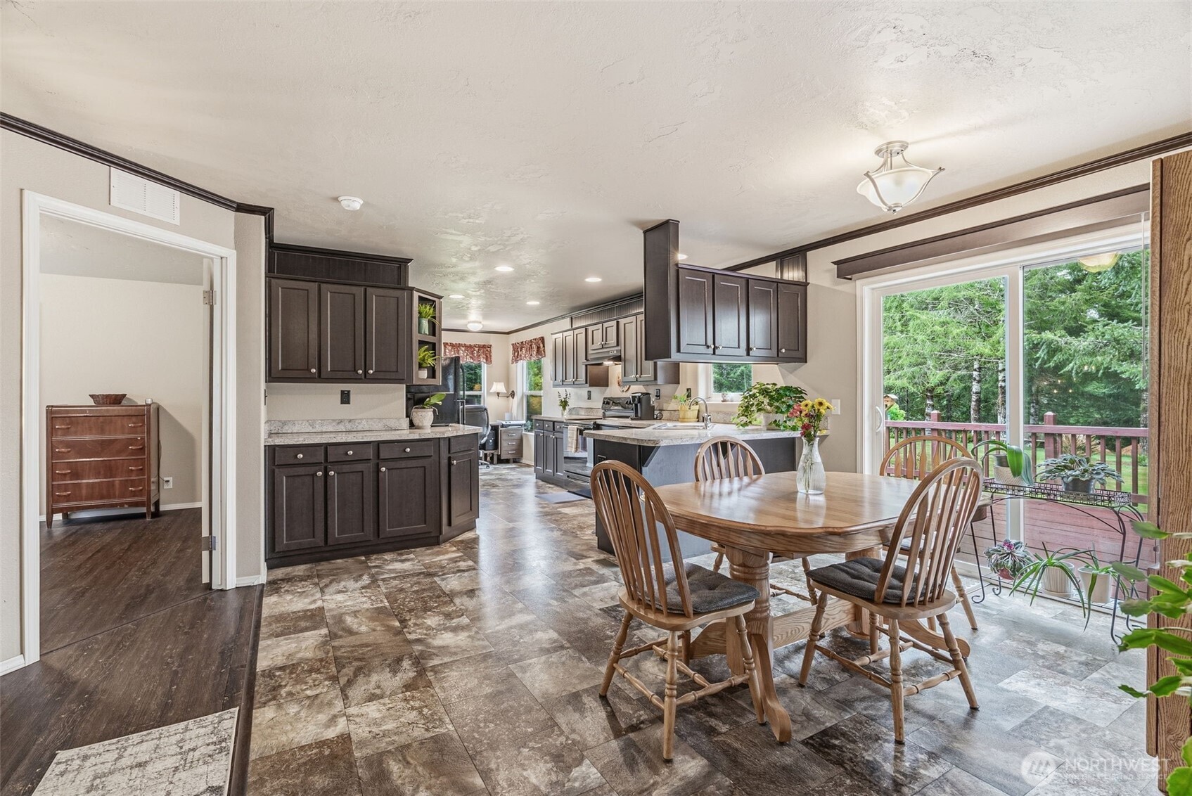 1047 Beaver Creek Road Cathlamet, WA 98612 - Photo 11 of 39 a dining area with a table chairs and a kitchen view