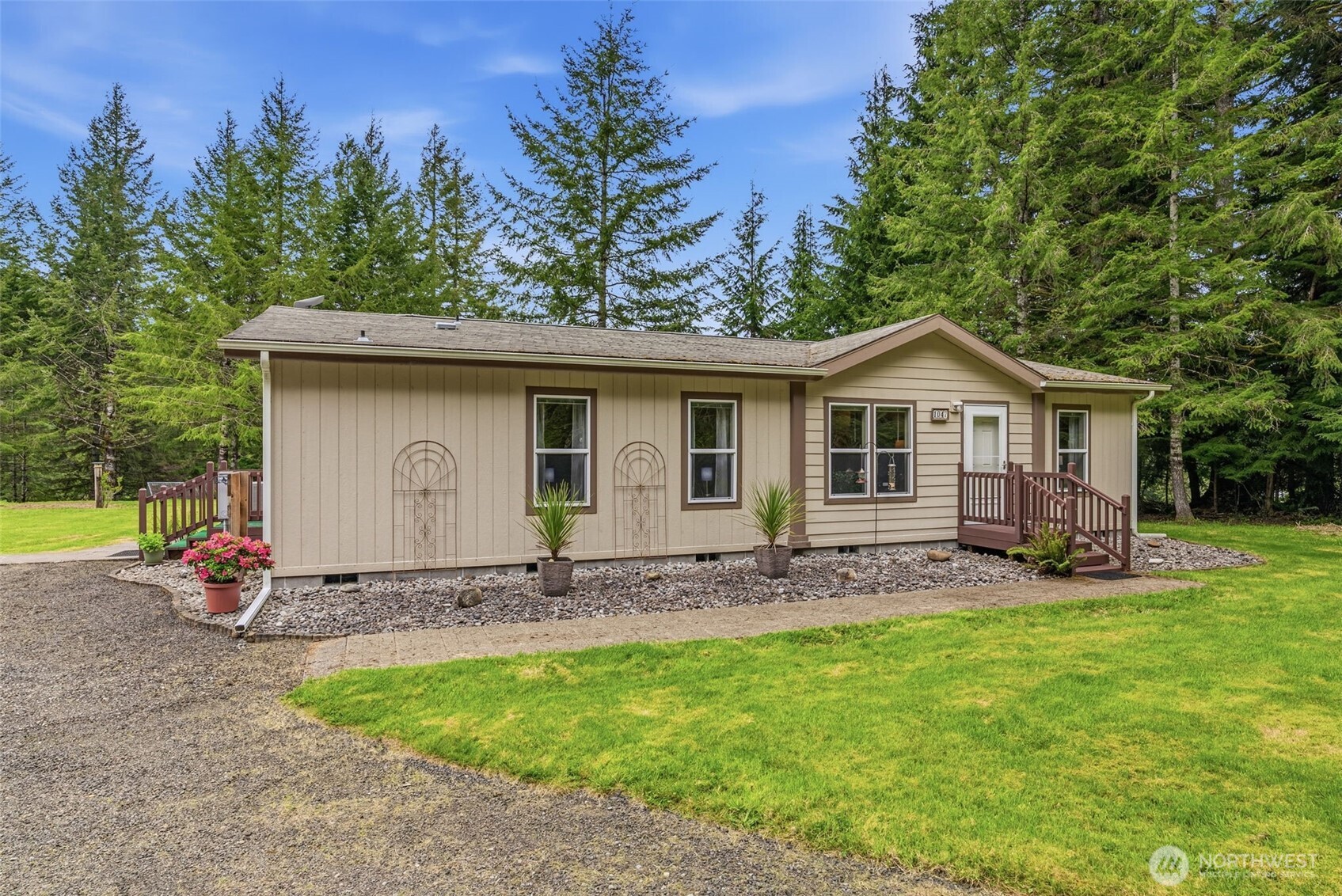 1047 Beaver Creek Road Cathlamet, WA 98612 - Photo 2 of 39 a front view of house with a garden and patio