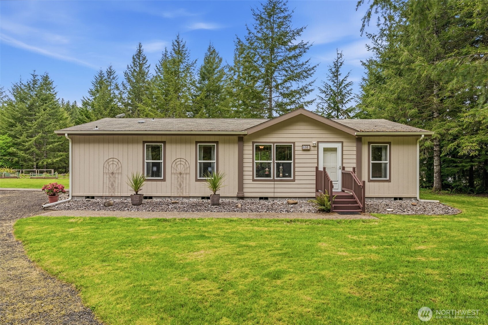 1047 Beaver Creek Road Cathlamet, WA 98612 - Photo 3 of 39 a front view of a house with a garden and yard
