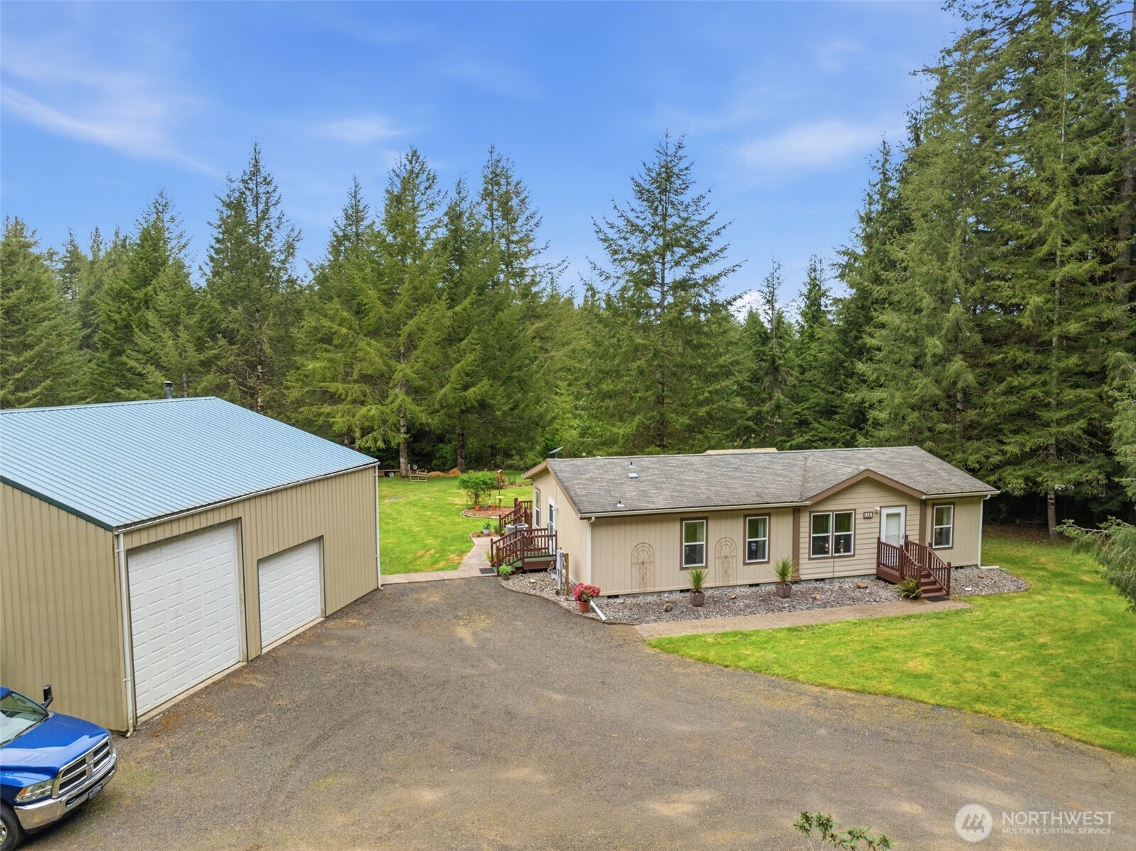 1047 Beaver Creek Road Cathlamet, WA 98612 - Photo 31 of 39 a front view of a house with a yard and garage