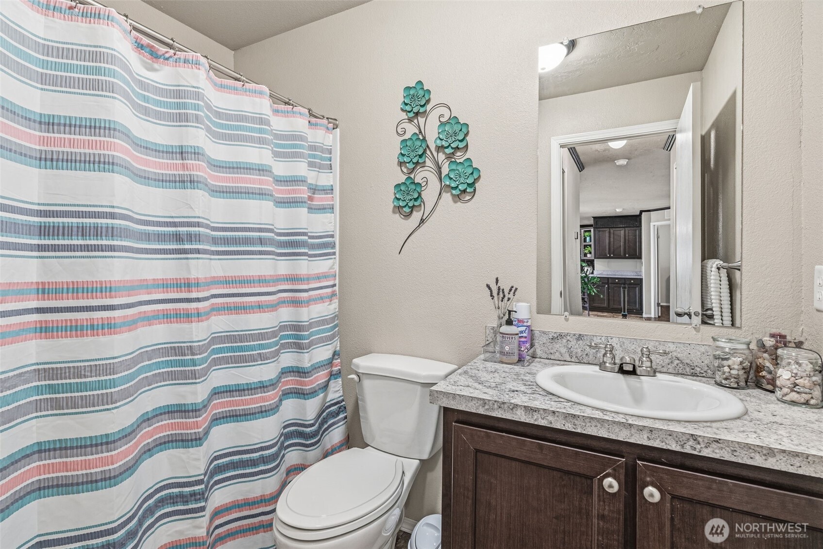 1047 Beaver Creek Road Cathlamet, WA 98612 - Photo 9 of 39 a bathroom with a granite countertop sink a toilet and a shower curtain
