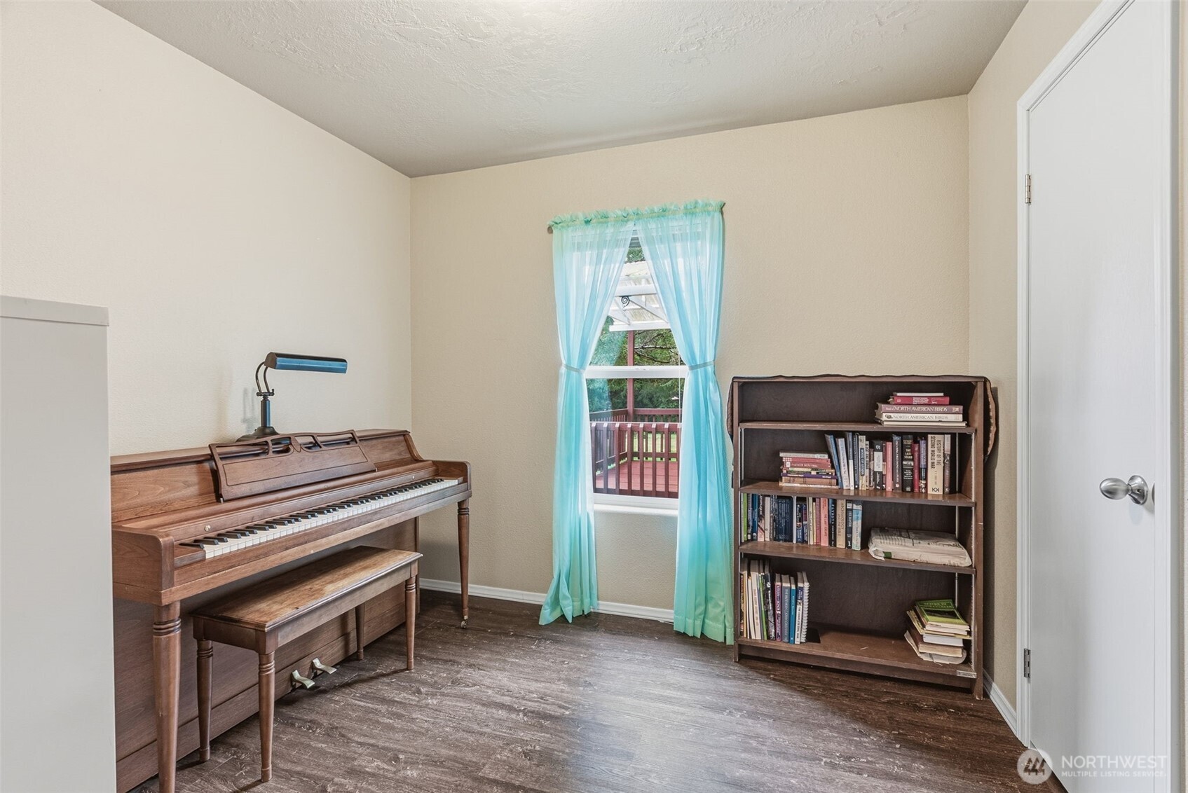 1047 Beaver Creek Road Cathlamet, WA 98612 - Photo 10 of 39 a room with a book shelf and wooden floor