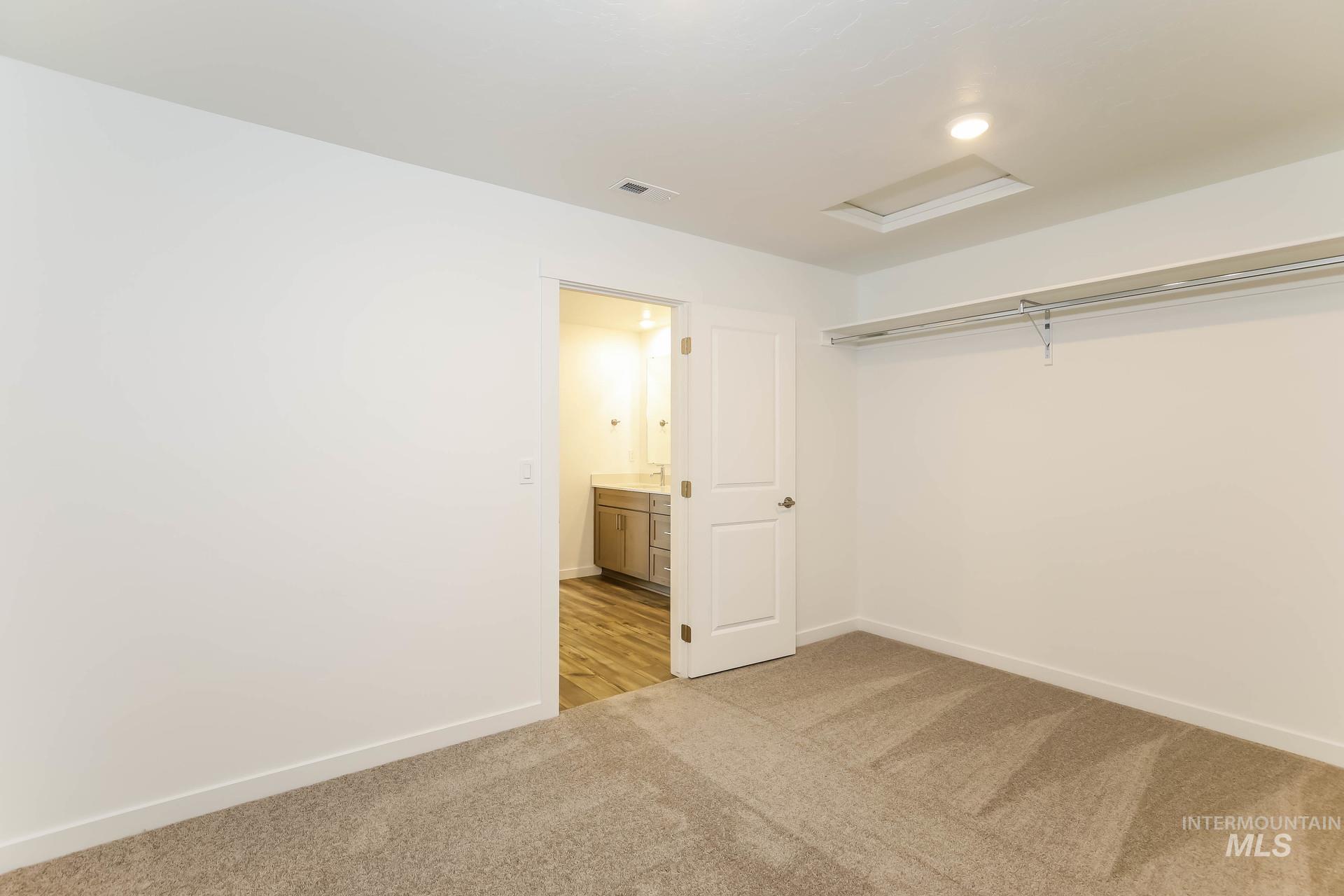 1918 East Springloyd Street Meridian, ID 83642 - Photo 17 of 20 Plush carpet flooring, recessed lighting, and built-in closet shelving