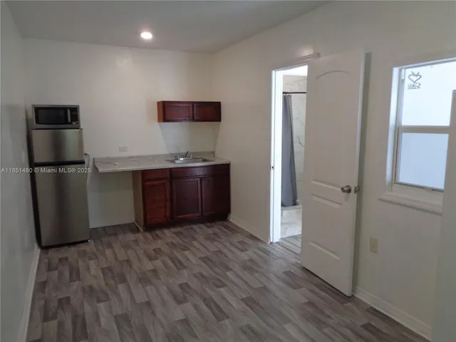 a kitchen with stainless steel appliances granite countertop a refrigerator and a sink