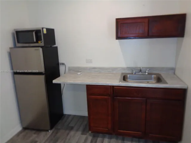 a kitchen with a refrigerator and a sink