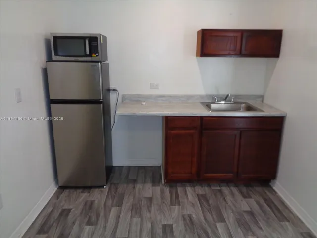 a kitchen with stainless steel appliances a refrigerator and a sink