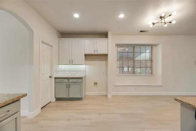 a kitchen with a refrigerator and window