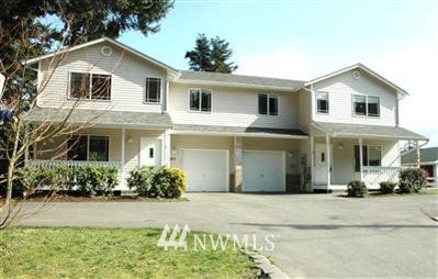 6805 Morgan Road Everett, WA 98203 - Photo 1 of 1 a view of a white house with a yard and potted plants