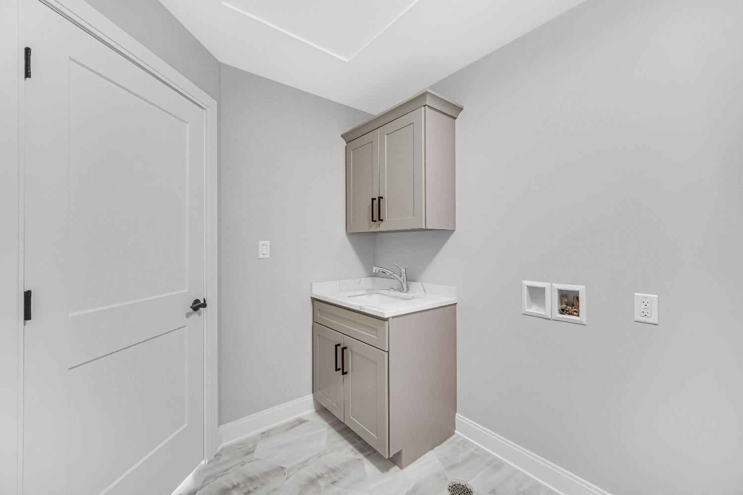 11039 Macedon Street Winfield, IN 46307 - Photo 17 of 36 a utility room with cabinets washer and dryer