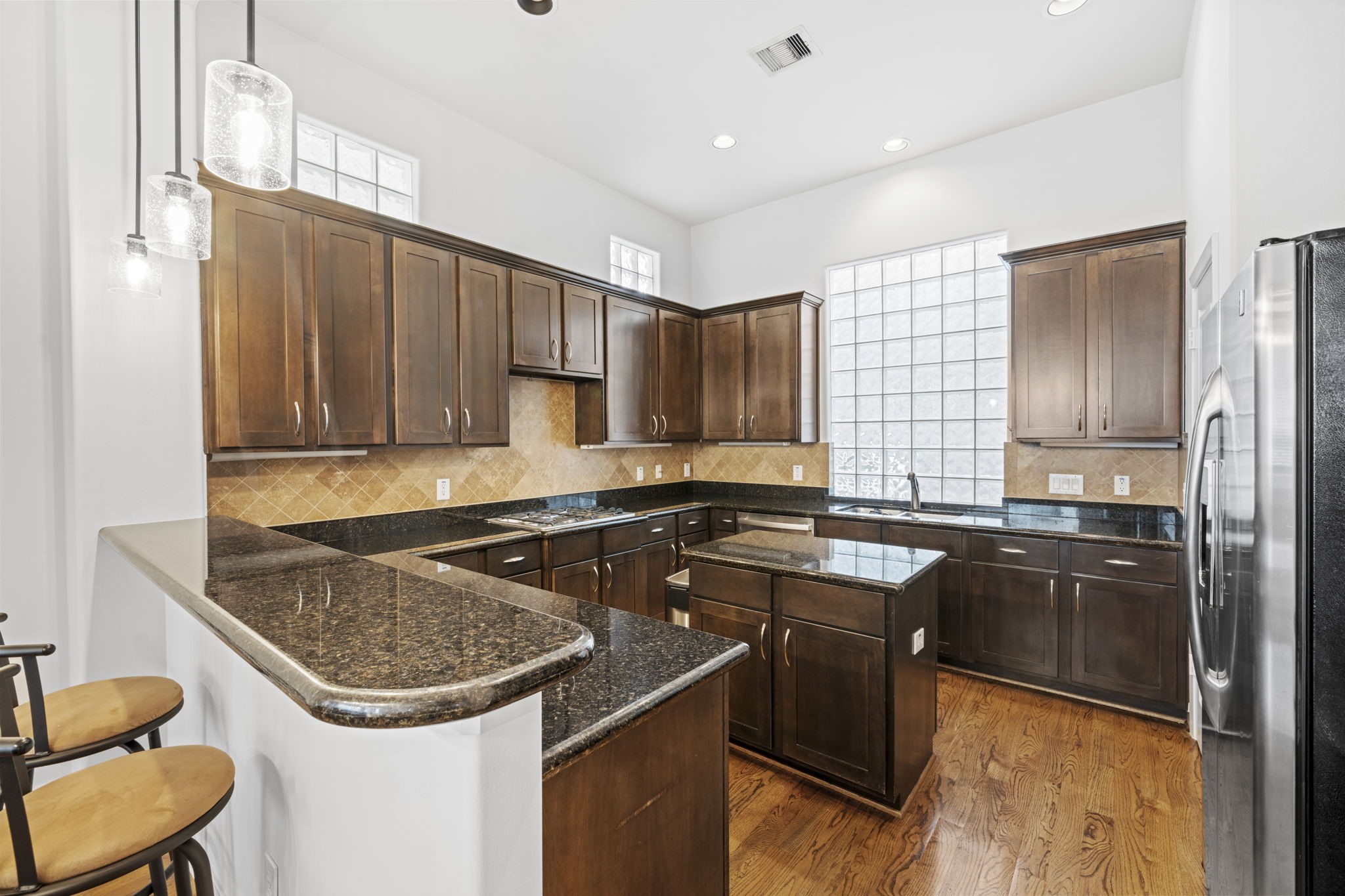 2413 Ralph Street, Unit 9 Houston, TX 77006 - Photo 4 of 19 The well-appointed kitchen features granite countertops, a center island, stainless steel appliances, abundant cabinetry, and a seamless flow into the living room