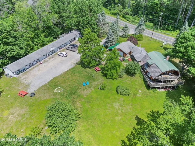 an aerial view of a house with swimming pool and garden