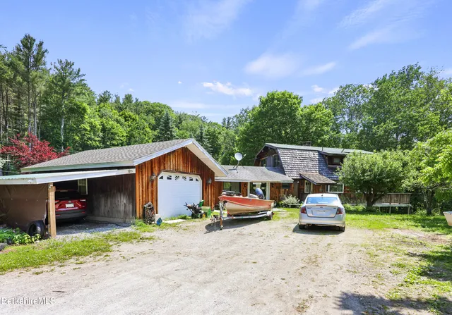 a front view of house with outdoor space and car parked