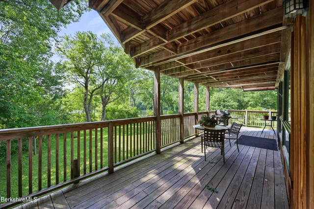 a view of a balcony with chairs and wooden floor