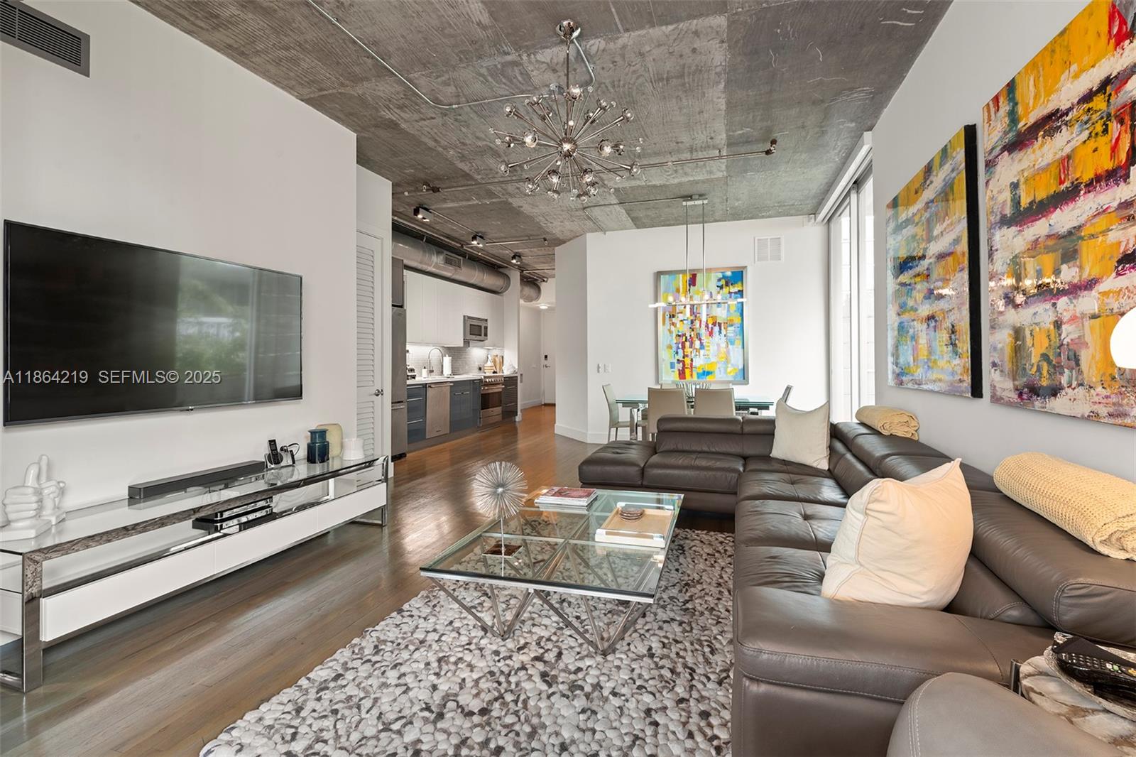 1700 Meridian Avenue, Unit 307 Miami Beach, FL 33139 - Photo 14 of 32 a living room with furniture and a flat screen tv