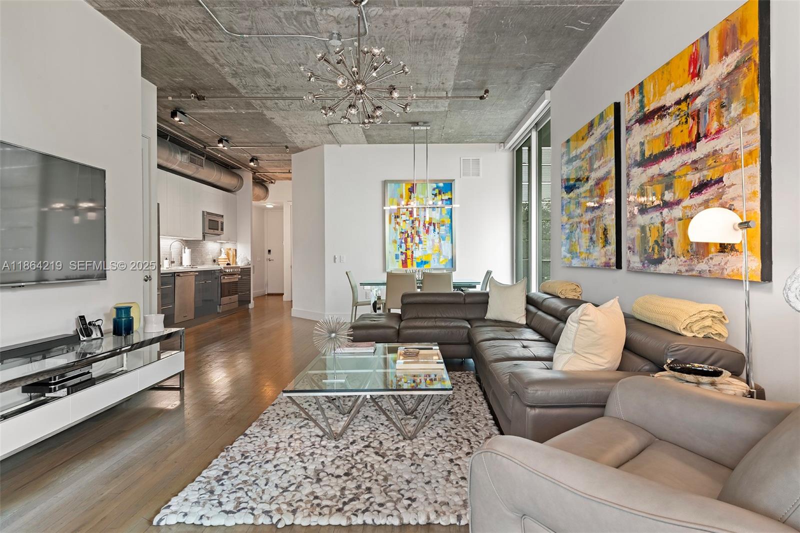 1700 Meridian Avenue, Unit 307 Miami Beach, FL 33139 - Photo 15 of 32 a living room with furniture and a chandelier