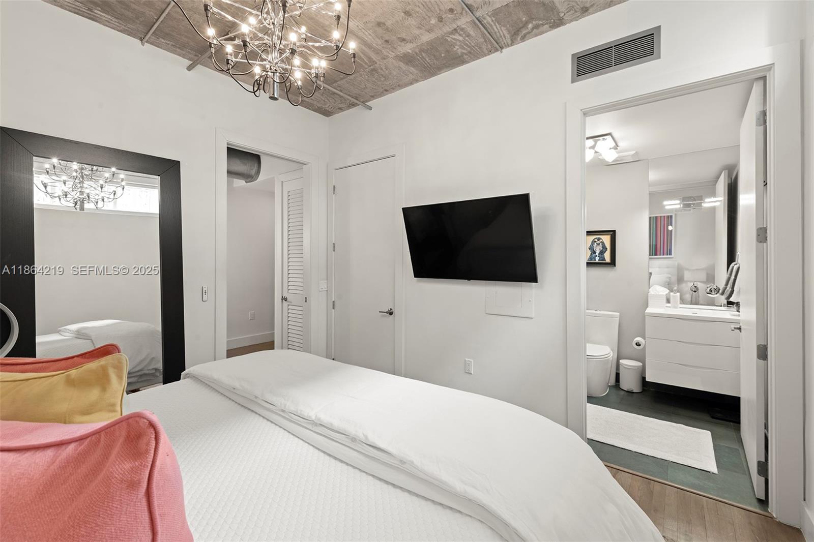 1700 Meridian Avenue, Unit 307 Miami Beach, FL 33139 - Photo 24 of 32 a bedroom with a bed and a flat screen tv