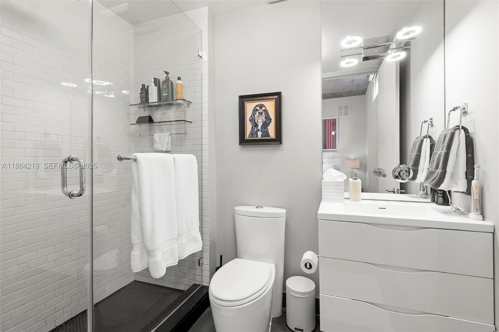 1700 Meridian Avenue, Unit 307 Miami Beach, FL 33139 - Photo 26 of 32 a bathroom with a toilet sink and shower