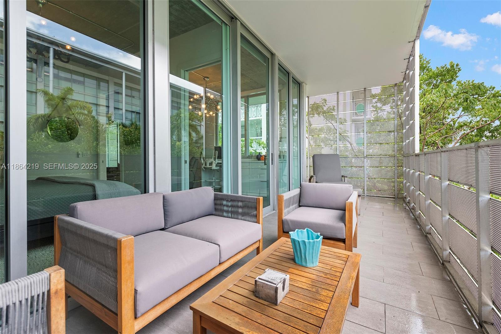 1700 Meridian Avenue, Unit 307 Miami Beach, FL 33139 - Photo 28 of 32 a balcony with furniture and a garden