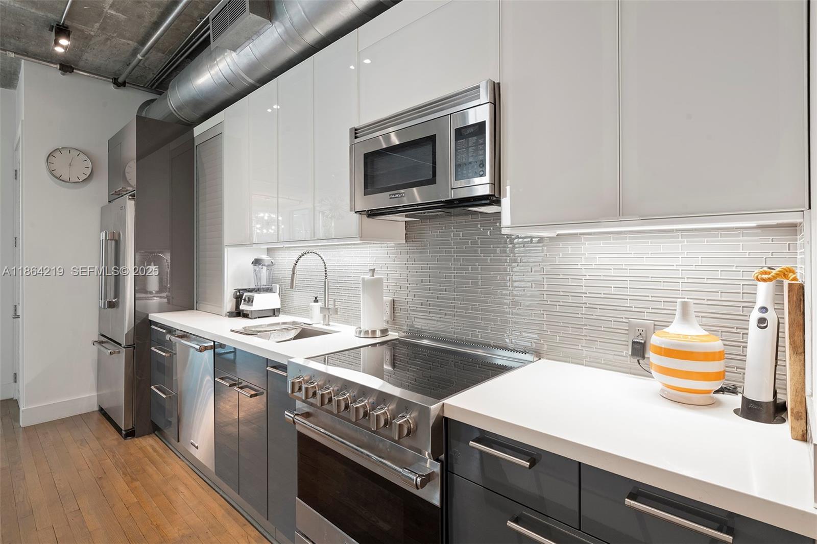 1700 Meridian Avenue, Unit 307 Miami Beach, FL 33139 - Photo 6 of 32 a kitchen that has a sink and a stove