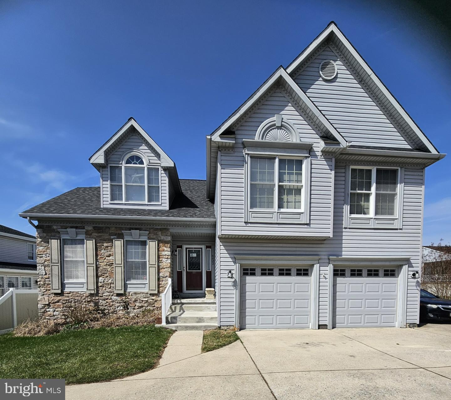 Charming two-story home with stone accents.