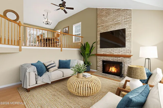 a living room with furniture a fireplace and a flat screen tv