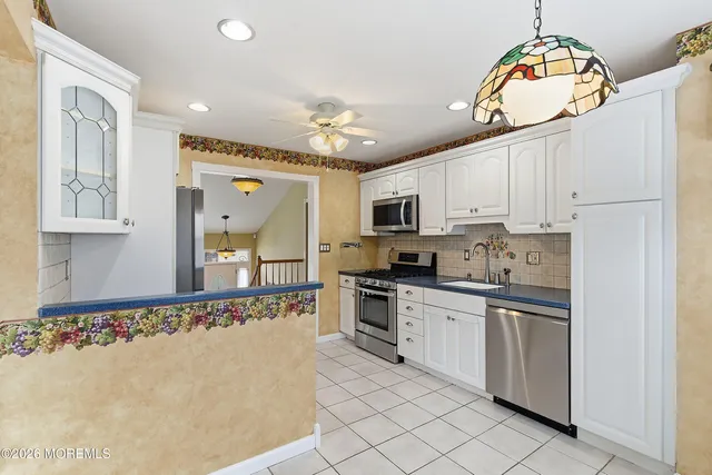 a kitchen with stainless steel appliances granite countertop a sink and cabinets