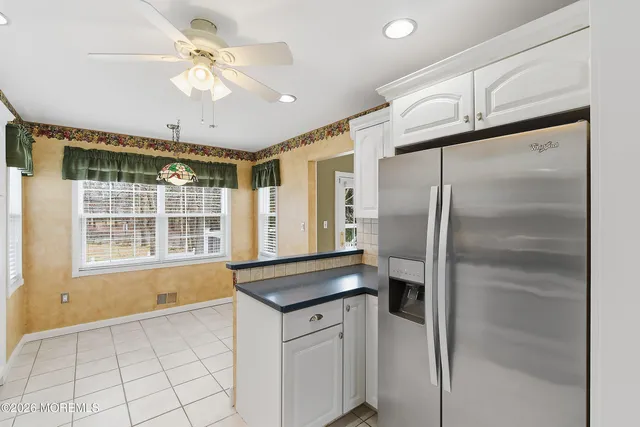 a kitchen with a refrigerator a sink and cabinets